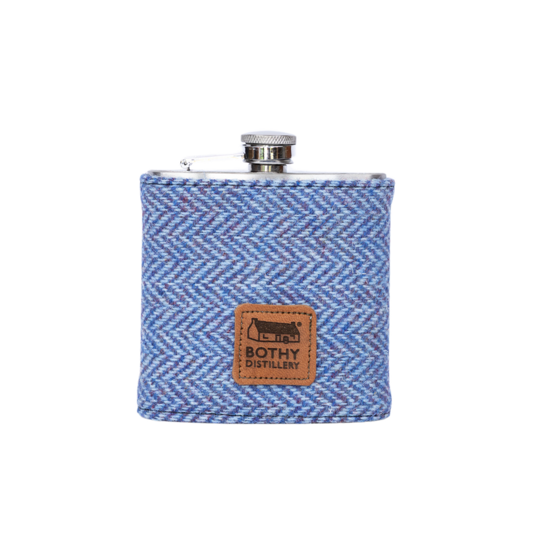 Blue herringbone patterned flask with a visible brand logo on a white background