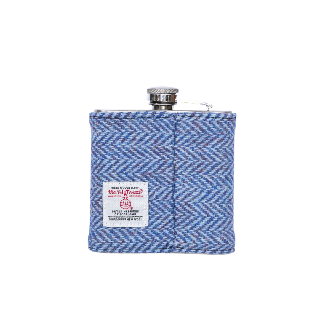 Blue herringbone patterned flask with a visible brand label on a white background